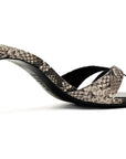 A single women's slingback heeled sandal with a snakeskin pattern in beige, brown, and black, featuring a low block heel and cutout straps, shown against a plain white background.