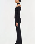 Woman wearing a black off-shoulder dress with long sleeves on a white background side
