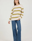 Woman wearing a striped sweater and blue jeans on a white background