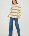 Woman wearing a striped sweater and jeans on a white background