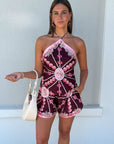 Woman wearing a patterned set with a white background