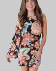 Woman wearing a floral dress on a gray background