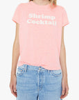 Person wearing a pink t-shirt with text and blue jeans on a white background