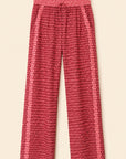 Red and pink patterned wide-leg pants with a drawstring waist, shown flat against a light beige background.