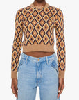 Woman wearing a patterned sweater and jeans on a white background