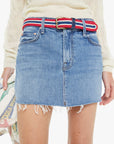 Denim skirt with a striped belt worn by a person, on a white background