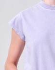 Light purple t-shirt worn by a person on a plain background