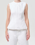 model wearing white denim top with a white background