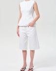 model wearing white denim top and shorts with a white background