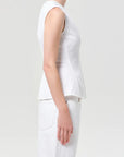 model wearing white denim top with a white background