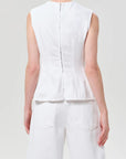 model wearing white denim top with a white background back view