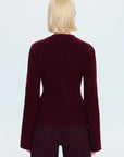 Woman wearing a burgundy cardigan on a white background back