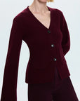 Woman wearing a burgundy cardigan on a white background side