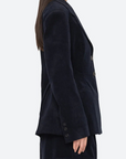 Woman wearing a dark blue blazer on a white background
