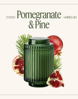 Green candle with pomegranate and pine elements on a white background