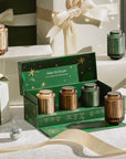 Set of candles in a decorative box with gift boxes and ribbons in the background