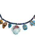Necklace with blue beads and various charms on a white background