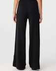 Black wide-leg pants worn by a person on a white background, back