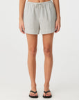 Person wearing checkered shorts on a white background
