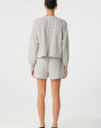 Person wearing a light gray striped shirt and shorts on a white background back