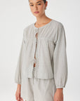 Woman wearing a checkered outfit on a white background