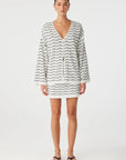 Woman wearing a striped dress on a white background