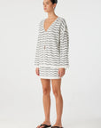 Woman wearing a striped dress on a white background