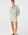 Woman wearing a striped cardigan on a white background