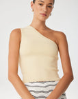 Woman wearing a beige one-shoulder top with a white background