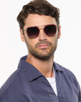Austin 12K Titanium + Burgundy Leather Sunglasses on male model with average oval face shape