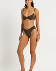 Woman size XS wearing a brown bikini set on a white background