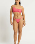 Model size M wearing Lotus Brief in Coral Pink and Lotus Crop in Coral Pink, front