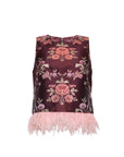 A sleeveless dark burgundy top featuring a pink and green floral brocade pattern and a light pink feather-trimmed hem, shown against a plain white background.
