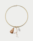 Gold necklace with shell and coral charms on a white background