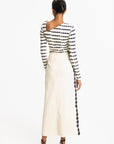 Woman wearing a Navy and white striped dress with a long train on a white background, back view