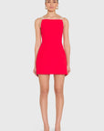model wearing a red dress with ivory straps standing on a white background