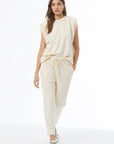 Woman wearing a beige outfit on a white background