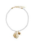 Necklace with shell pendant and gold accents on a white background