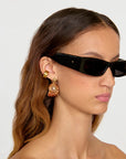 Caracol Earrings right side view on model