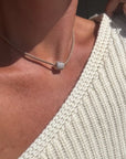 Coco Sand Silk Cord Necklace on model with charm in center