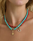 model wearing charm enhancer turquoise gemstone necklace layered with a coral necklace