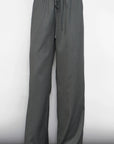 Gray wide-leg pants worn by a person on a white background