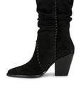 Black suede boot with a block heel on a white background