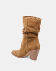 Brown suede boot on a white background