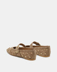 A pair of taupe-brown suede Mary Jane flats decorated with gold-tone metal studs and buckle straps, shown from a side-rear angle on a light gray background.