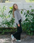 Toronto Sneaker shown on a women with black jeans and stripe top