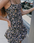 Close up of side view of a woman wearing Ivy Skort Bubble dress standing by a window