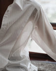 White shirt with sheer overlay draped over a surface