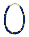 Blue beaded necklace with gold accents on a white background