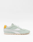 Light green sneaker with a yellow accent on a white background